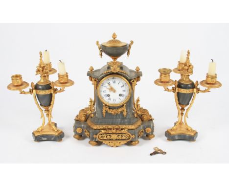 A late 19th Century French grey marble and ormolu clock garniture, the clock having applied ormolu decorations with urn shape