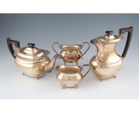 A four piece silver tea set, comprising of a teapot, water jug, sugar bowl and sugar bowl, all with beaded rim and raised on 