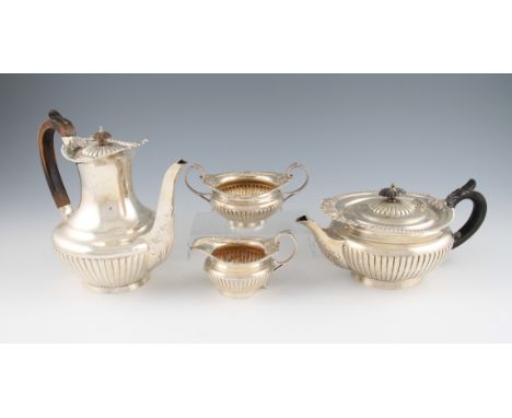 A matched Victorian four piece silver tea set, comprising of a Goldsmiths & Silversmiths Co Ltd. teapot and water jug and a E