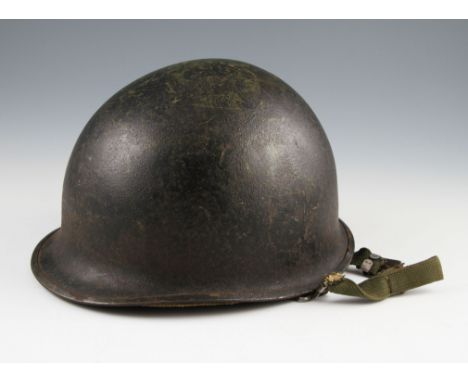 A US M1 pattern helmet with black on green finish with liner.