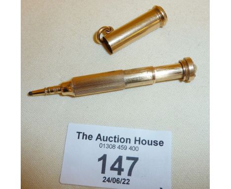 Miniature gold fob or chatelaine propelling pencil, set with diamonds and pearl to finial. Approx. 32mm long when closed and 