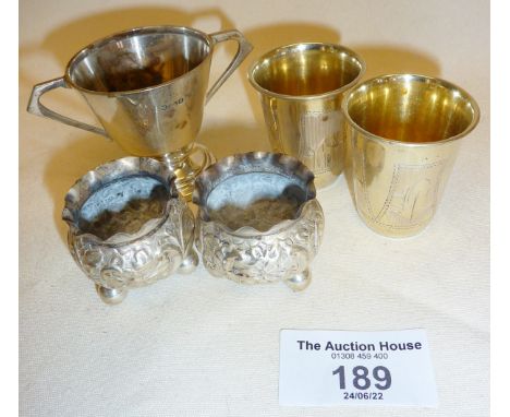 Pair of Russian silver gilt engraved vodka shot cups, hallmarked silver pair of salts and a hallmarked silver small trophy, a