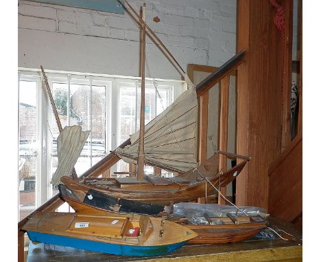 Scale wooden models of a Chinese sailing junk, a sampan and a wooden model of a Riva speedboat with electric motor