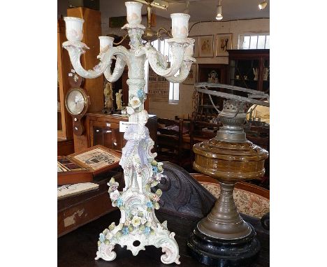 Continental porcelain five-branch candle stick centrepiece and an oil lamp