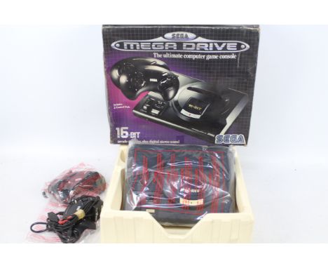 Sega - A boxed Sega Megadrive 16 BIT console with with 2 x Control Pads. The unit appears physically in Good condition, it is