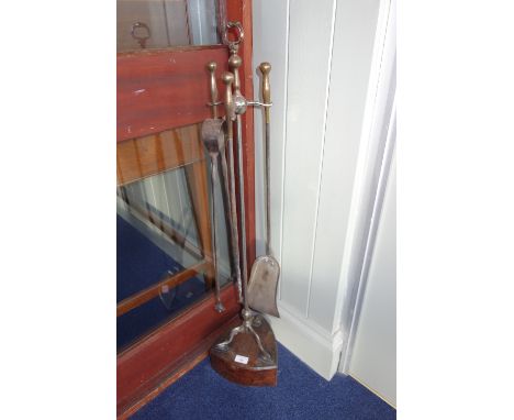 A SET OF THREE POLISHED STEEL AND BRASS FIRE TOOLS, with stand