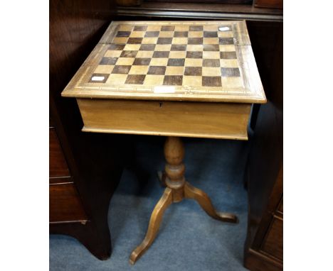 A 19TH CENTURY WORK TABLE, with fitted interior and chess board top, on a tripod base, 72 cm high x 37 cm wide