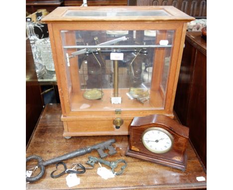 A SET OF SCIENTIFIC SCALES in a glazed case, a mantel clock and a collection of keys