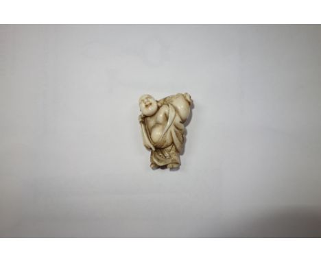 A JAPANESE MEIJI PERIOD IVORY NETSUKE, modelled as a figure carrying a sack, 4.5cm high 