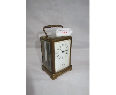 A 19TH CENTURY BRASS CASED CARRIAGE CLOCK, with white enamel dial and subsidiary dial, sticking on a bell (with key)