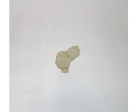A 18TH CENTURY CHINESE WHITE JADE, modelled in the form of a dog, Qing, 3cm