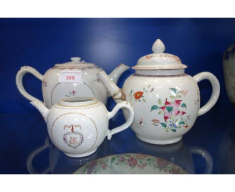 AN 18TH CENTURY CHINESE ARMORIAL TEAPOT, (missing cover) and two 18th Chinese export teapots, decorated with flowers in polyc