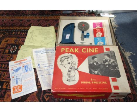 J.S. FRIEZE & CO LTD: A Peak Cine 8mm projector, hand driven, in original box with packaging and three boxed films, c.1950