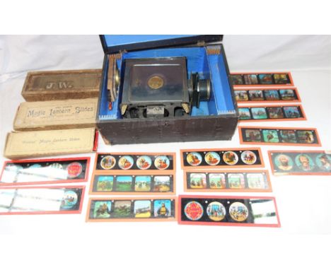 AN EARLY 20TH CENTURY MAGIC LANTERN by A.W. Gamage Ltd, London, in fitted case with a collection of slides