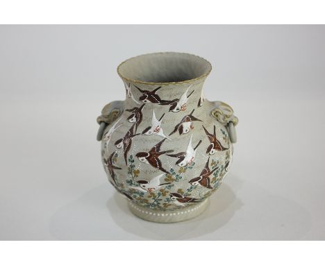 A small Japanese urn shaped vase, the body decorated with bird of prey in a flock of flying birds and shrubs, with two side '