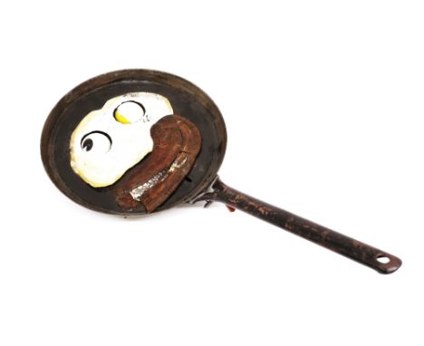Eric Morecambe's stage props. A frying pan with moveable eyes (eggs) and mouth (bacon)  ❧ This is from Eric Morecambe’s priva