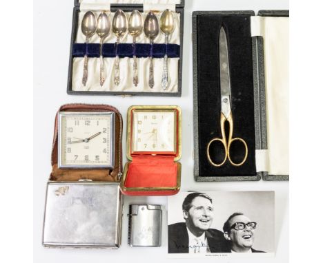 Eric Morecambe's Ronson cigarette lighter, engraved "E.M."; a white metal cigarette case; two travel alarm clocks by Smiths a
