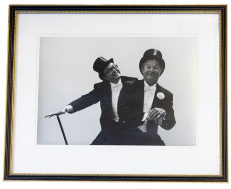 Arnold Newman (American, 1918-2006) Portrait photograph of Eric Morecambe & Ernie Wise in white tie, top hats and tails at Ro