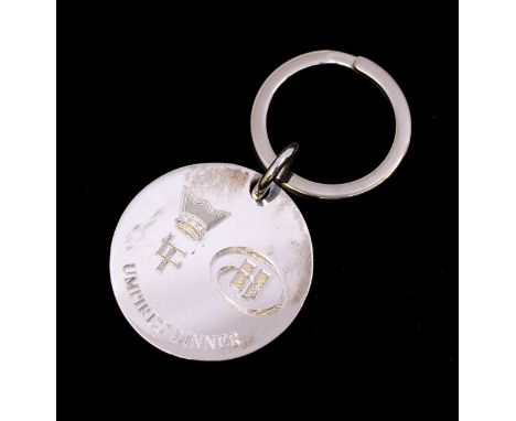 A silver keyring, circular form, inscribed 'Umpires Dinner' diameter approx. 35mm, feature hallmarks Birmingham Harrison Brot