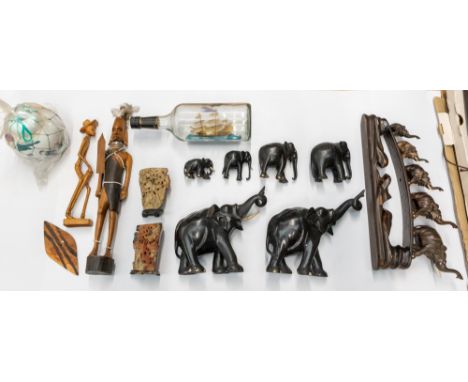 A collection of Tourist ware including ebony elephants, tribal carvings, Chinese ginger jar, a ship in a Captains Morgan bott