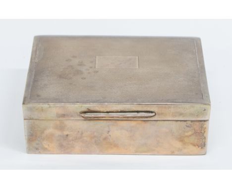 An Elizabeth II silver engine turned cigarette box, the cover with vacant cartouche, lined interior, bakelite base, hallmarke