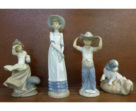 Four Nao figures including puppy figure group, height of tallest 32cm