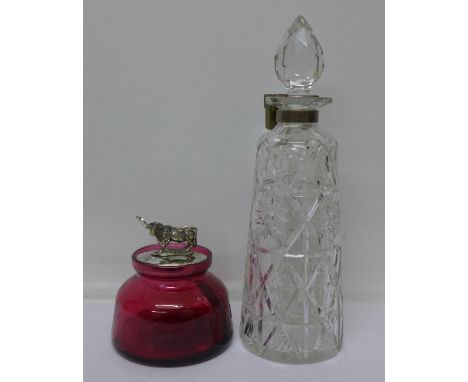 A ruby glass preserve with plated top and cow finial and a cut crystal glass decanter with lockable top, no key