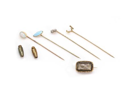A small collection of stick pins and a mourning brooch, comprising a diamond stick pin, an opal stick pin, a plain stick pin,