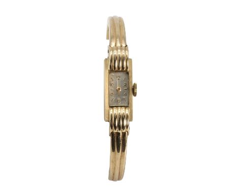 A 9ct gold ladies' mechanical bangle watch, the bevelled rectangular case with a silvered dial, gilt Arabic numerals and gilt