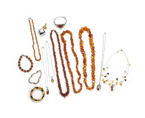A collection of amber jewellery, to include a silver amber openwork floral bangle, with a central amber cabochon, internal di