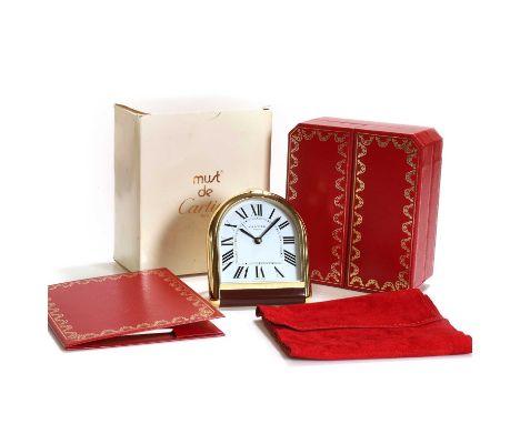 A Must De Cartier quartz desk clock, a Must De Cartier gold plated desk/alarm clock, with white dial and Roman numeral hour m