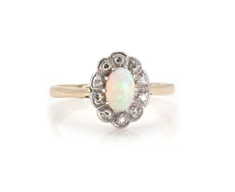 An opal and diamond cluster ring, with a central oval cabochon opal, claw set, surrounded by ten single-cut diamonds, grain s