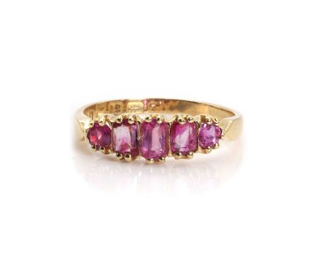 A Victorian 18ct gold ruby five stone ring,  with three graduated oval mixed cut rubies, flanked to either side by a round cu