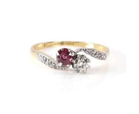 A ruby and diamond Toi et Moi ring,  with a transitional cut diamond, estimated as 0.20ct approximately, and a round cut ruby