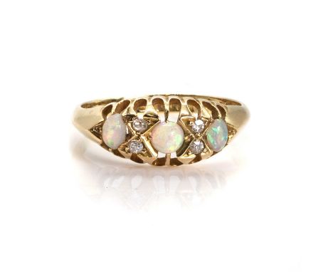 A late Victorian 18ct gold opal ring,  the boat shaped head with alternating round and oval opal cabochons, to eight cut diam