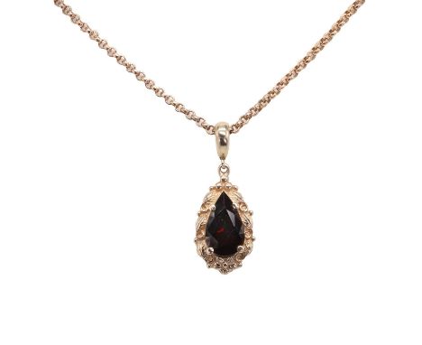 A garnet pendant on chain, featuring a pear cut garnet, claw set to a foliate mount with a tapered bale, stamped 9ct, suspend