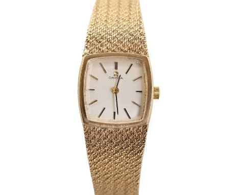 A ladies' 9ct gold Omega mechanical bracelet watch,  with a tonneau-shaped case, 20 x 20mm, a silvered dial, gilt hour batons