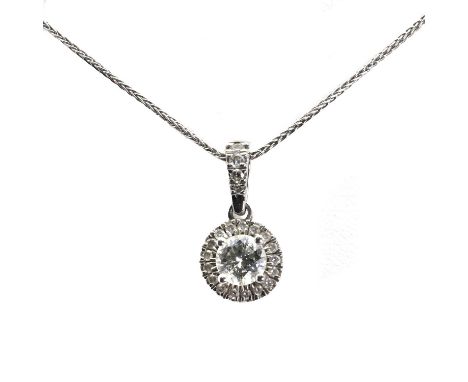 A platinum diamond cluster pendant, centrally set with a round brilliant cut diamond, estimated as approximately 0.50ct, with