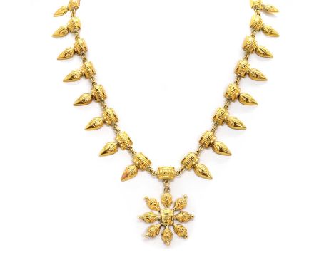 A high carat gold necklace, the front section comprising a series of fringes with reeded detailing, with a central floral mot