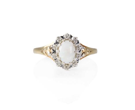 A 9ct gold opal and diamond cluster ring,  a central oval opal cabochon, 7mm x 5mm, with a surround of illusion set eight cut