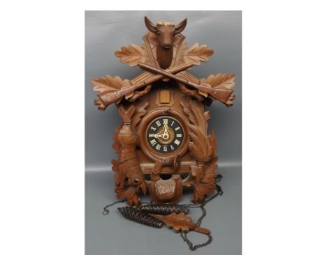 20th century Black Forest wall mounted cuckoo clock with hanging game detail and heavily carved throughout, mounted with a st