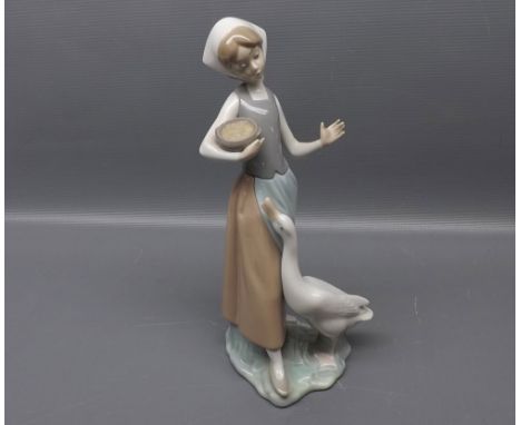 Lladro figure of lady feeding a goose, 9 ins tall  