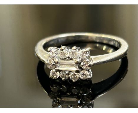 18ct White gold diamond ring set with central baguette diamonds & 10 brilliant cut round diamonds Weight 3.3g Size M