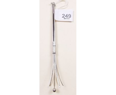 A white metal swizzle stick