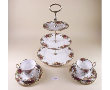 A Royal Albert Country Roses tea service comprising: six cups and saucers, six tea plates, cake plat and three tier cake stan