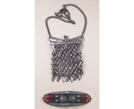 An Art Deco enamel buckle and a white metal Art Nouveau dragonfly evening purse