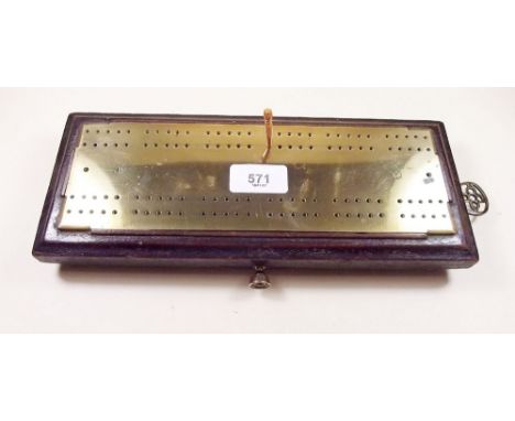An old cribbage board with brass mount