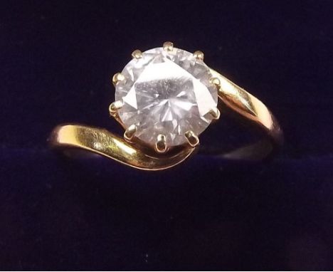 An 18 carat gold large solitaire diamond ring with crossover setting - approx 1.47 carats, size P