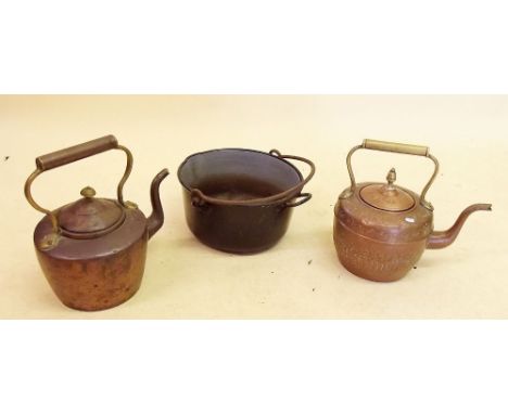 An enamel pot and two copper kettles