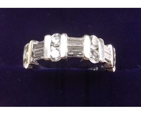 An 18k white gold ring set six baguette cut and eight brilliant cut diamonds (total .99 carats) size M